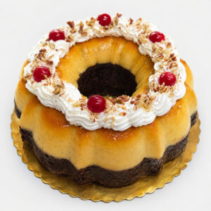 Big chocoflan with caramel flan, chocolate cake, whipped cream, cherries, and chopped nuts