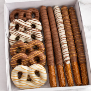 Chocolate covered pretzels and pretzel sticks dipped in milk chocolate, white chocolate, and caramel drizzle